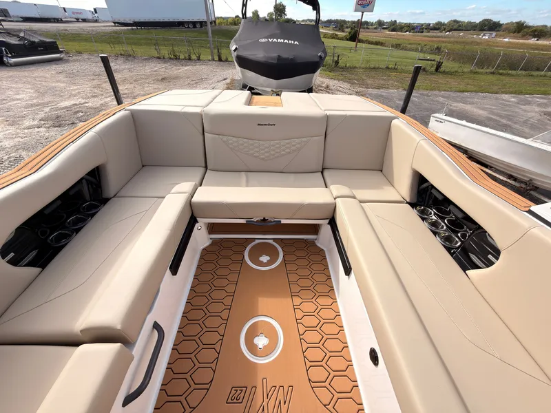 Slide: The Image of The image shows the interior of a 2027 MasterCraft NXT22 with beige seating and stylish flooring. - 17