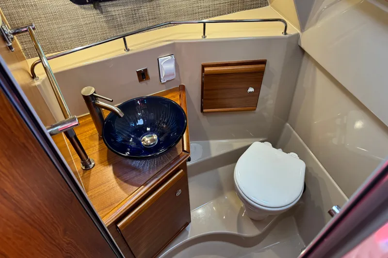 Slide: The Image of 2018 Ranger Tugs R-27 boat bathroom with modern sink and compact toilet. - 21