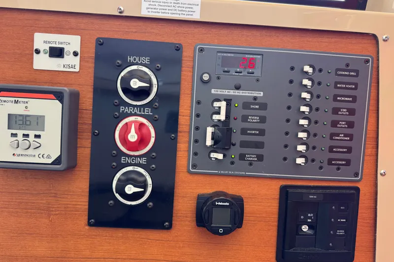 Slide: The Image of Electrical control panel of a 2018 Ranger Tugs R-27 boat with various switches and meters. - 24
