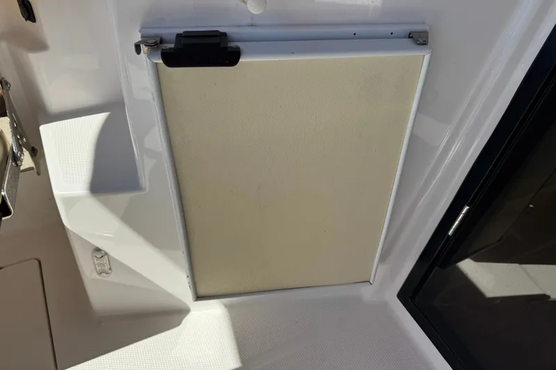 Slide: The Image of 2018 Ranger Tugs R-27 interior detail, featuring a closed compartment door. - 9