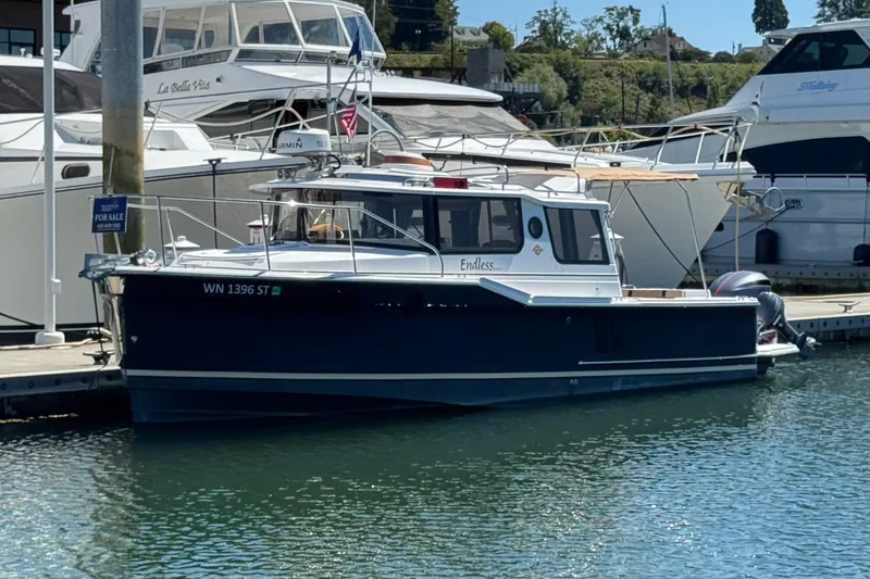 The Image of 2018 Ranger Tugs R-27 boat docked, for sale, with other boats in the background. - 0