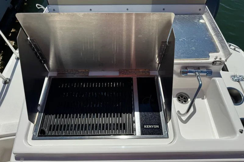 Slide: The Image of Outdoor grill and sink on 2018 Ranger Tugs R-27 boat deck. - 28