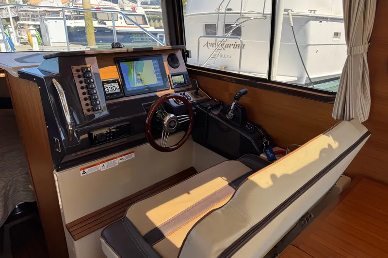 Slide: The Image of Interior helm of 2018 Ranger Tugs R-27 with navigation equipment and steering wheel. - 15