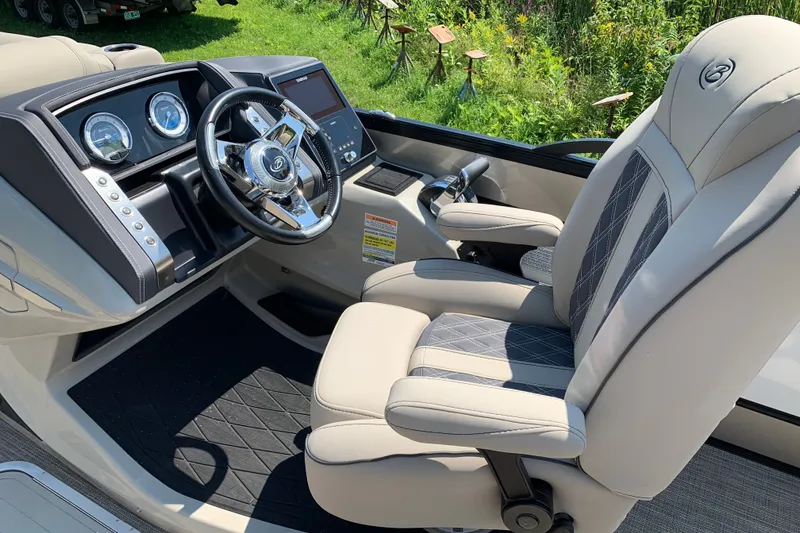 Slide: The Image of 2022 Barletta Lusso 23UC boat interior with luxurious captain's chair and modern dashboard. - 12