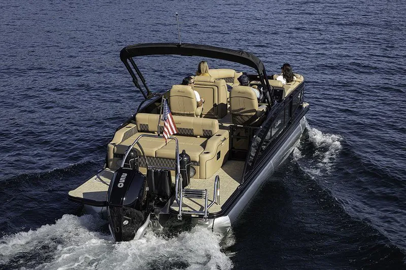 Slide: The Image of Manufacturer Provided Image: 2022 Barletta Lusso 23UC pontoon boat cruising on water, rear view. - 23