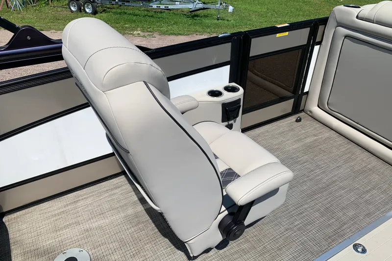 Slide: The Image of 2022 Barletta Lusso 23UC boat interior with plush seating and cup holders. - 11