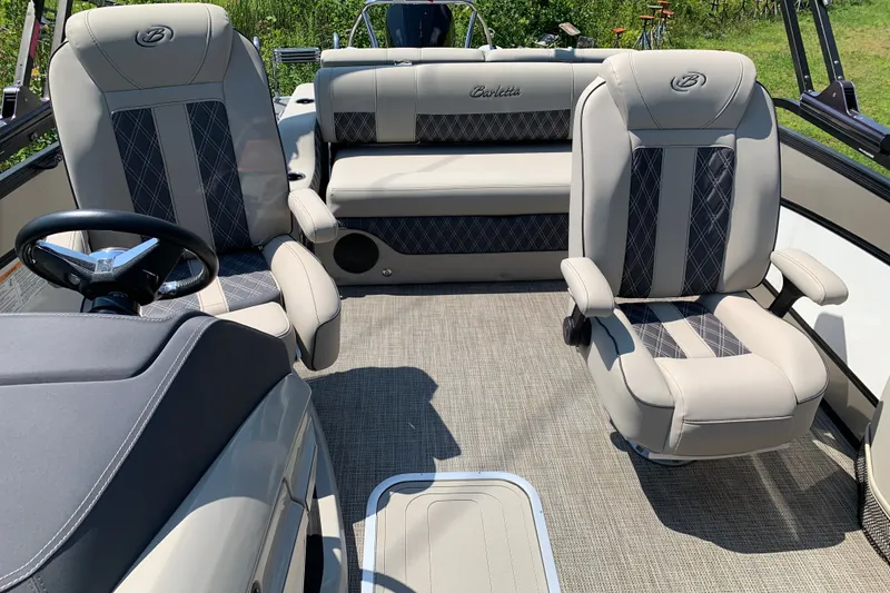 Slide: The Image of 2022 Barletta Lusso 23UC boat interior with luxurious seating and steering wheel. - 20