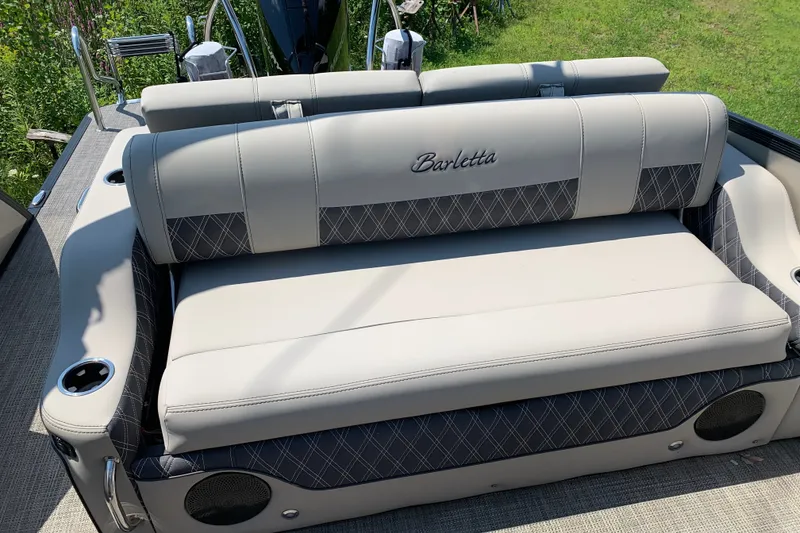 Slide: The Image of 2022 Barletta Lusso 23UC boat seating with elegant upholstery and integrated cup holders. - 6