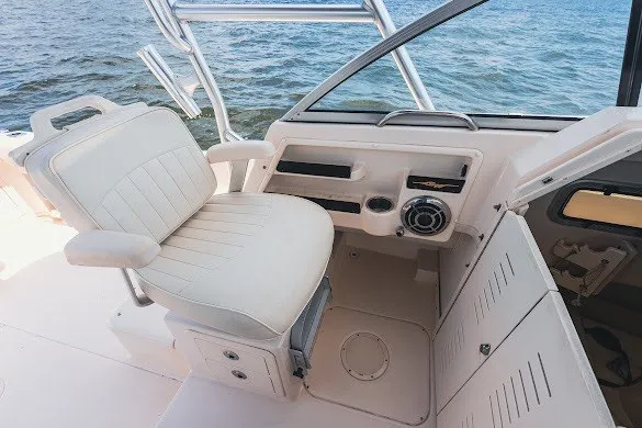 Slide: The Image of 2013 Grady-White Gulfstream 232 boat interior with helm seat and ocean view. - 22