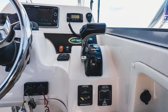Slide: The Image of Control panel of a 2013 Grady-White Gulfstream 232 boat, featuring steering and throttle controls. - 20