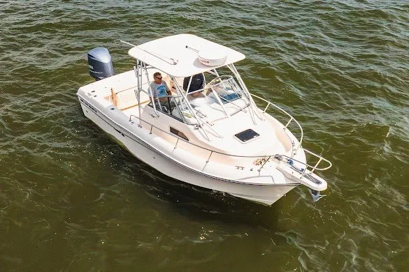 Slide: The Image of 2013 Grady-White Gulfstream 232 boat cruising on open water. - 26