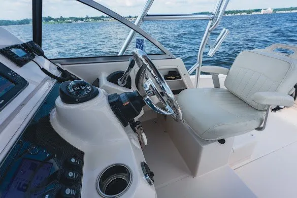 Slide: The Image of Helm of 2013 Grady-White Gulfstream 232 boat with steering wheel and captain's chair. - 23
