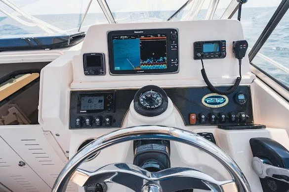 Slide: The Image of Cockpit of 2013 Grady-White Gulfstream 232 with navigation equipment and steering wheel. - 19