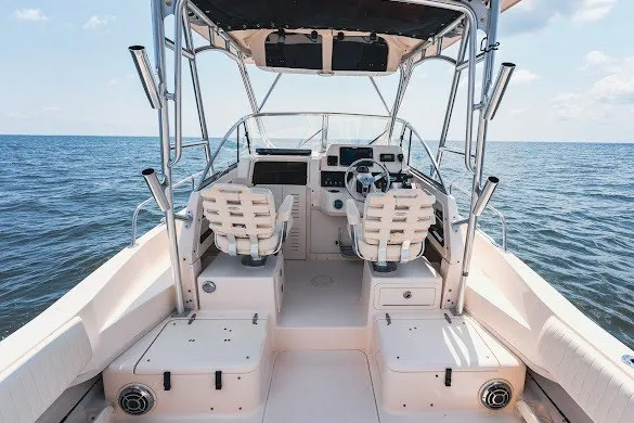 Slide: The Image of 2013 Grady-White Gulfstream 232 boat interior with dual seats, steering wheel, and ocean view. - 17