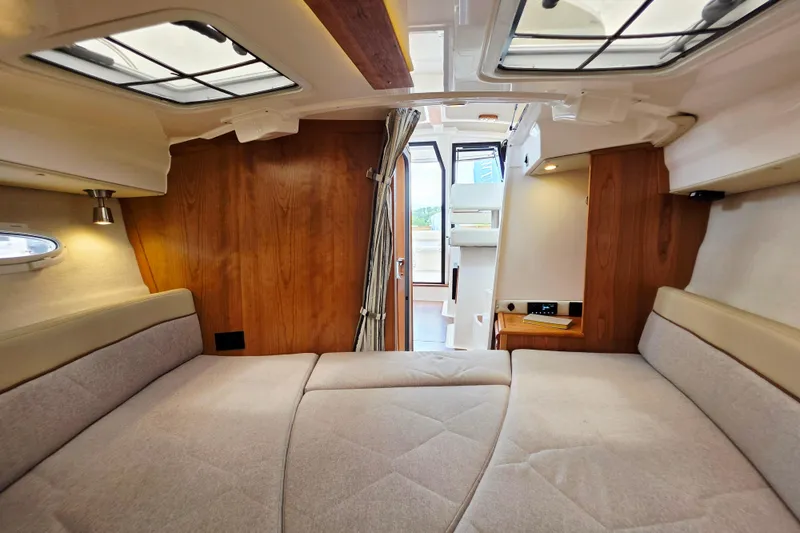 Slide: The Image of Interior of 2027 Cutwater C-248 Coupe, featuring cozy cabin with wood accents and skylights. - 18
