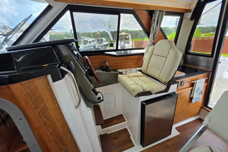 Slide: The Image of Interior of 2027 Cutwater C-248 Coupe boat with helm, seating, and kitchenette. - 24