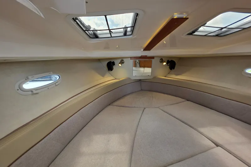 Slide: The Image of Interior of 2027 Cutwater C-248 Coupe boat, featuring cozy cabin with skylights. - 19