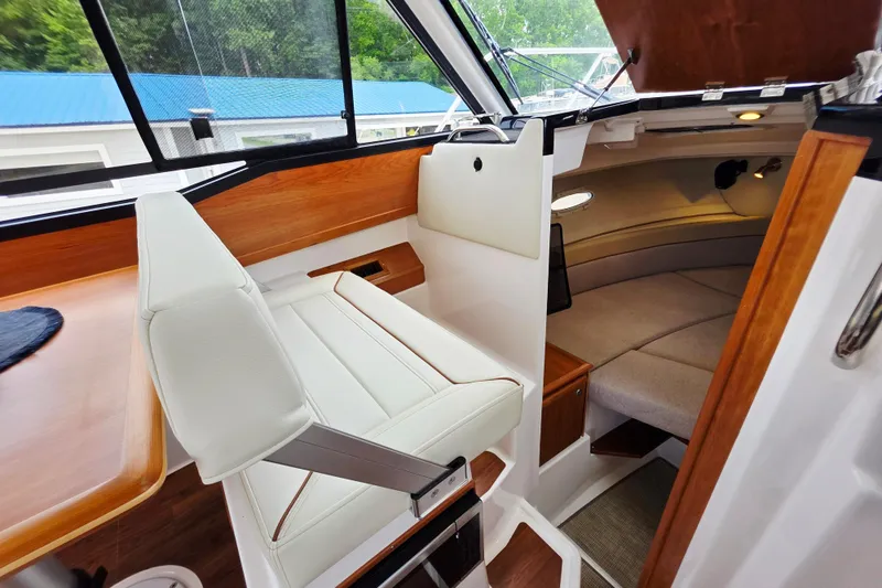 Slide: The Image of 2027 Cutwater C-248 Coupe interior with white seating and cozy cabin space. - 16