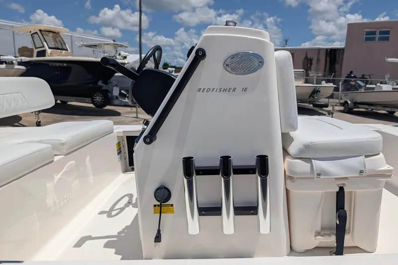Slide: The Image of 2022 Hewes Redfisher 18 boat interior with steering console and rod holders. - 25