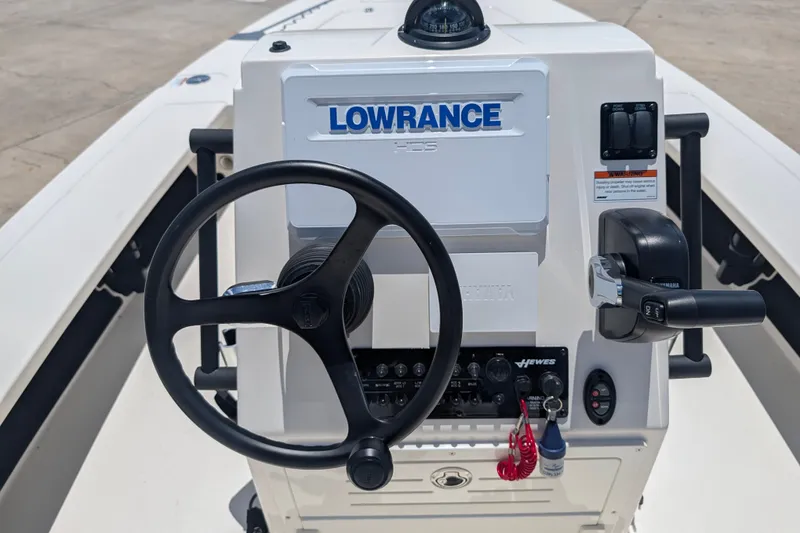 Slide: The Image of 2022 Hewes Redfisher 18 boat console with steering wheel and Lowrance electronics. - 14