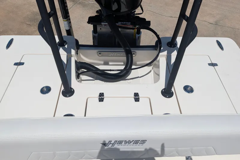 Slide: The Image of 2022 Hewes Redfisher 18 boat deck with motor and seating details. - 16