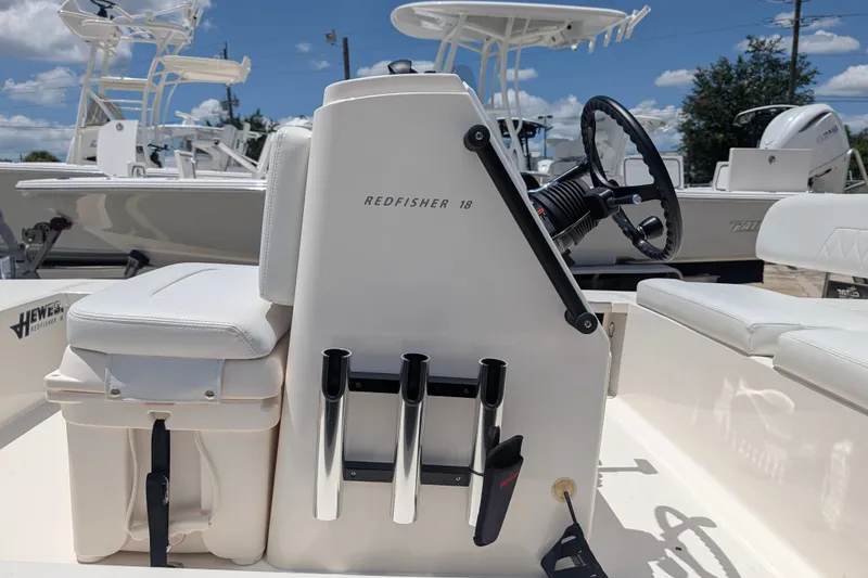 Slide: The Image of 2022 Hewes Redfisher 18 boat interior with steering wheel and rod holders. - 24