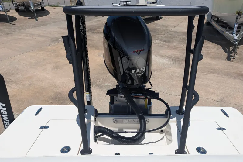 Slide: The Image of 2022 Hewes Redfisher 18 boat with Yamaha 115 engine, displayed outdoors. - 15