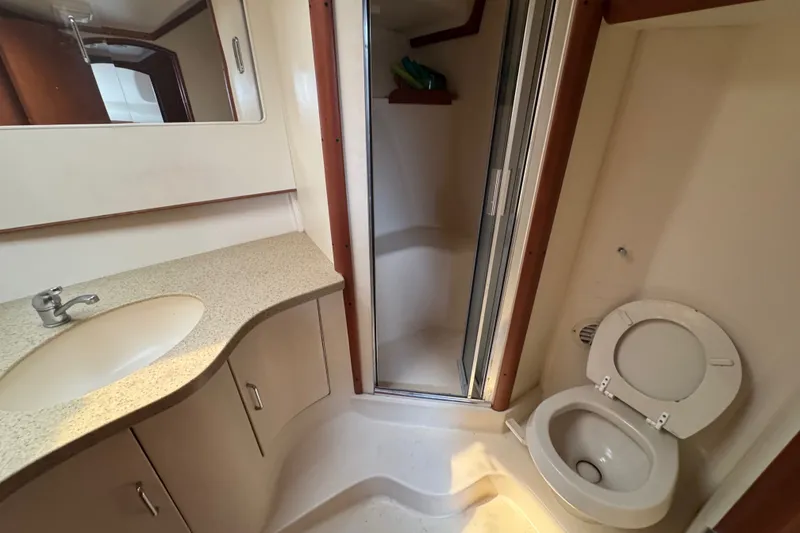 Slide: The Image of 2004 Luhrs 38 Convertible yacht bathroom with sink, shower, and toilet. - 29