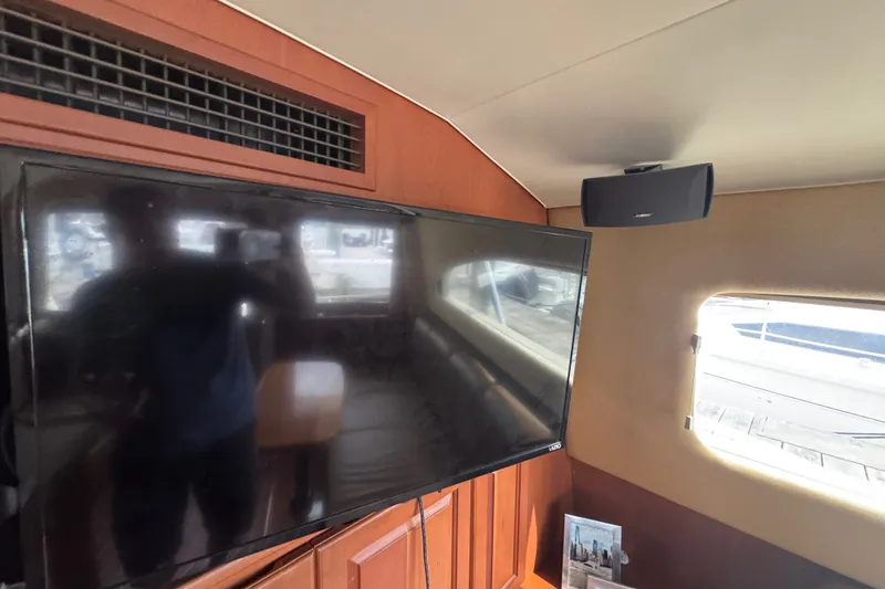 Slide: The Image of Interior of 2004 Luhrs 38 Convertible yacht with TV and speaker setup. - 26