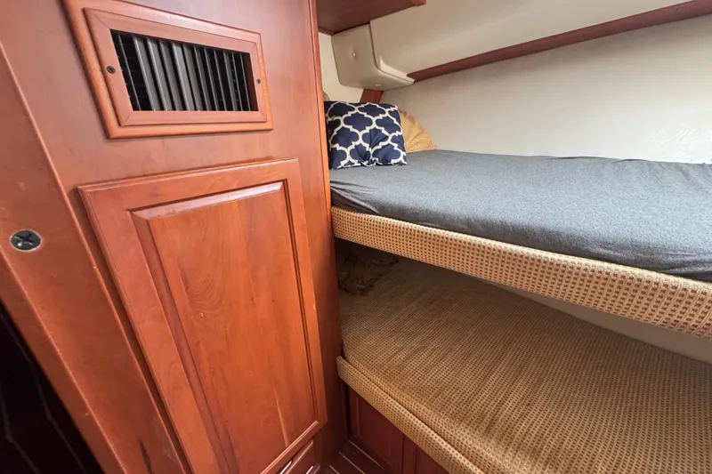 Slide: The Image of Interior of 2004 Luhrs 38 Convertible yacht with wooden cabinetry and bunk beds. - 28