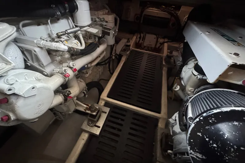 Slide: The Image of Engine room of a 2004 Luhrs 38 Convertible boat, showcasing mechanical components. - 30