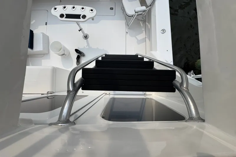 Slide: The Image of Staircase view on 2004 Luhrs 38 Convertible yacht deck, featuring fishing rod holders. - 40