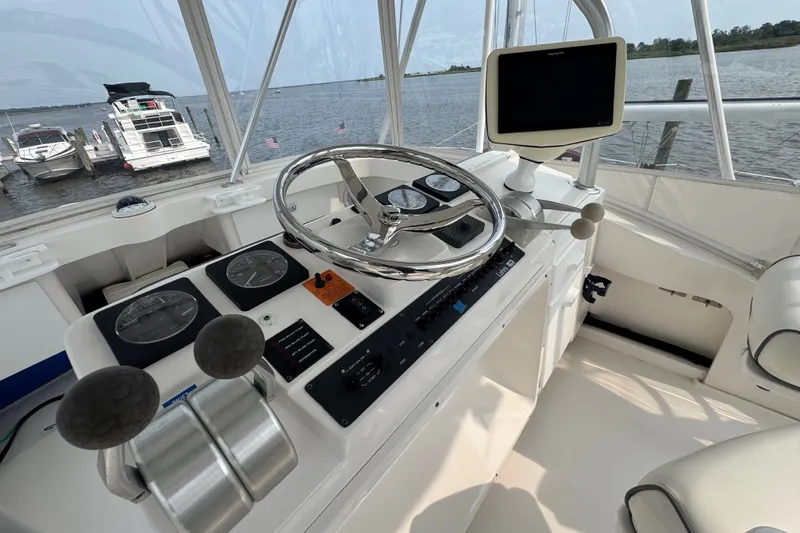 Slide: The Image of Helm of 2004 Luhrs 38 Convertible boat with steering wheel and navigation equipment. - 36