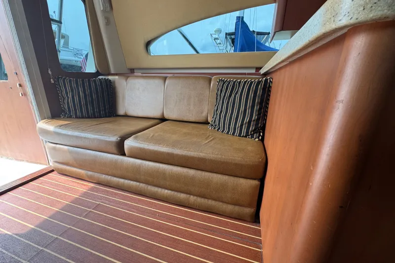 Slide: The Image of Interior of 2004 Luhrs 38 Convertible yacht with leather sofa and striped cushions. - 21