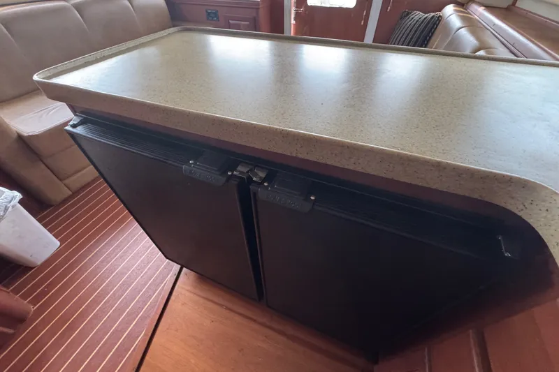 Slide: The Image of 2004 Luhrs 38 Convertible yacht interior with countertop and dual-door refrigerator. - 24