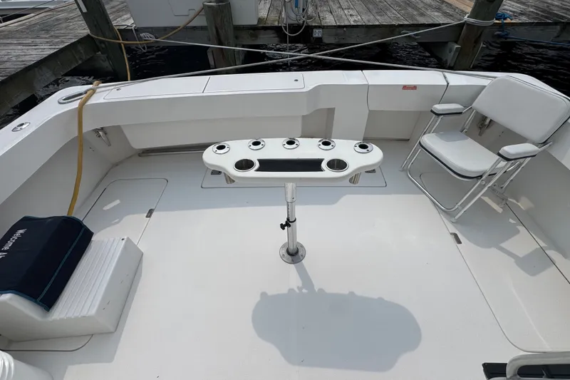 Slide: The Image of 2004 Luhrs 38 Convertible boat deck with fishing rod holders and seating. - 14