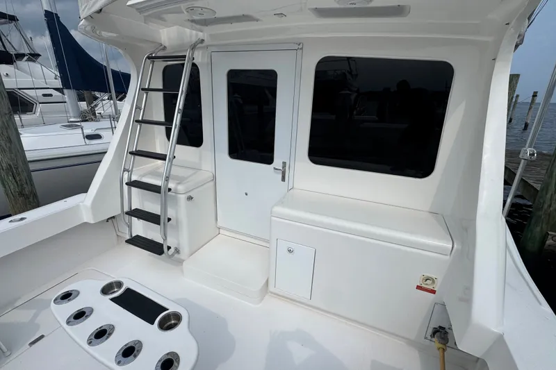 Slide: The Image of 2004 Luhrs 38 Convertible yacht deck with ladder and storage compartments. - 16