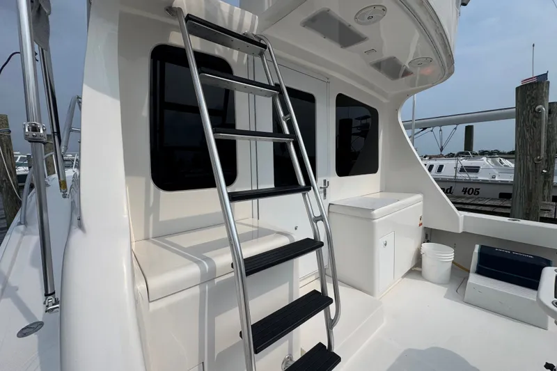 Slide: The Image of The 2004 Luhrs 38 Convertible features an exterior ladder and spacious deck area. - 15