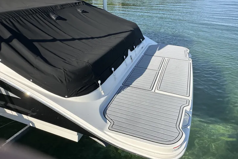 Slide: The Image of 2017 Sea Ray SDX 270 boat with covered deck, floating on clear water. - 1