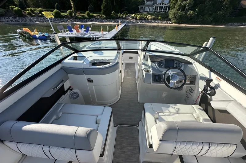 Slide: The Image of 2017 Sea Ray SDX 270 boat interior with helm, seating, and lake view. - 3