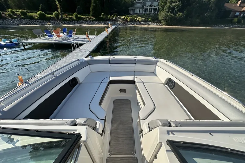Slide: The Image of 2017 Sea Ray SDX 270 boat interior with spacious seating, dock, and waterfront view. - 2