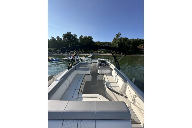 Slide: The Image of 2017 Sea Ray SDX 270 boat with spacious seating on a sunny day by the water. - 5