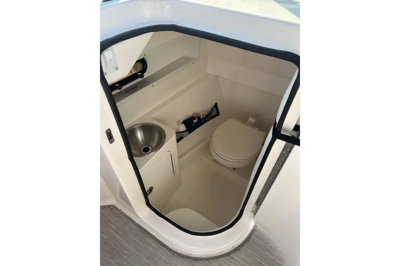 Slide: The Image of Interior of 2017 Sea Ray SDX 270 boat bathroom with sink and toilet. - 9