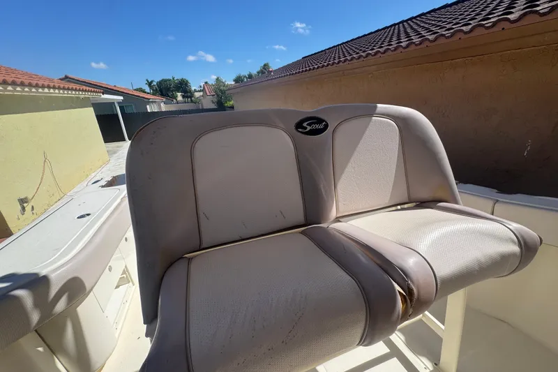 Slide: The Image of 2008 Scout 282 Sportfish boat seat with logo, outdoor setting, sunny day. - 56