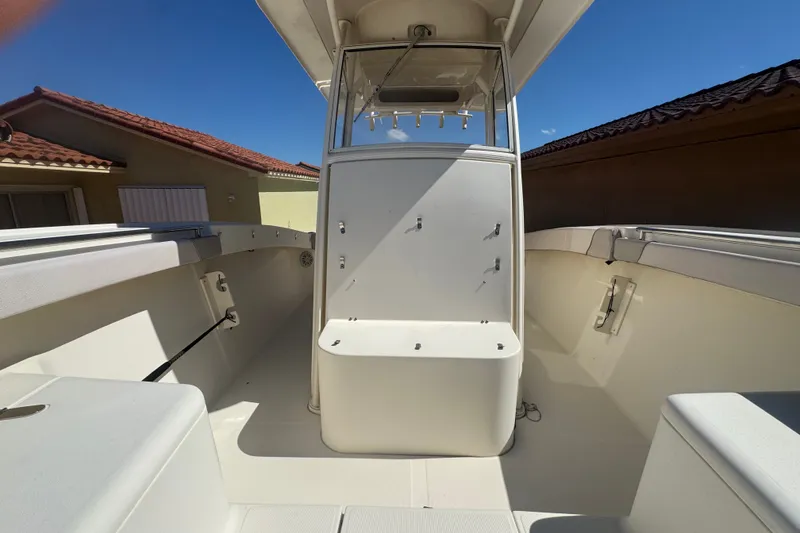 Slide: The Image of 2008 Scout 282 Sportfish boat interior with seating and console under clear blue sky. - 33