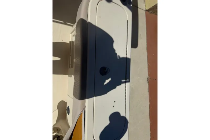 Slide: The Image of 2008 Scout 282 Sportfish boat deck with shadows and storage compartment. - 71