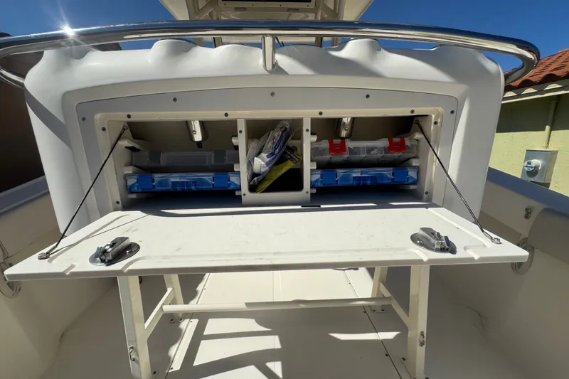 Slide: The Image of 2008 Scout 282 Sportfish boat storage compartment with organized fishing gear and accessories. - 59