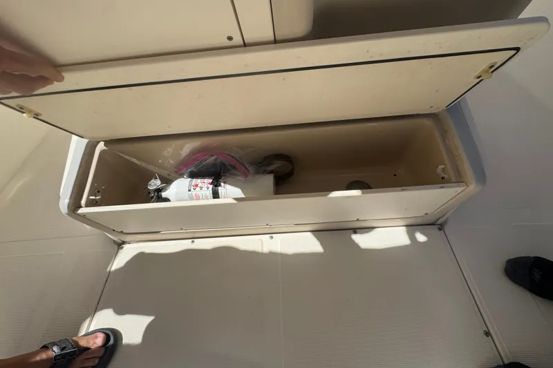 Slide: The Image of Open storage compartment on 2008 Scout 282 Sportfish boat with fire extinguisher inside. - 40