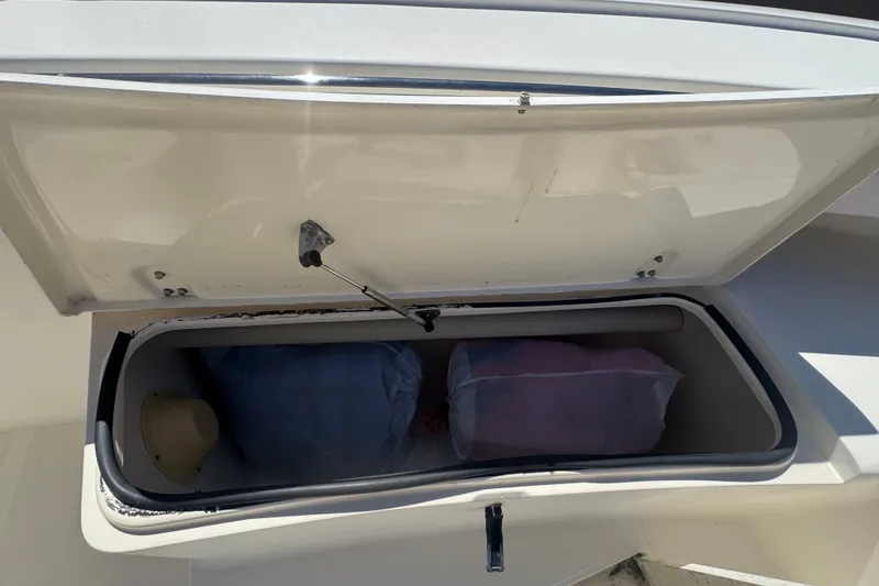 Slide: The Image of Open storage compartment on 2008 Scout 282 Sportfish boat with bags inside. - 30