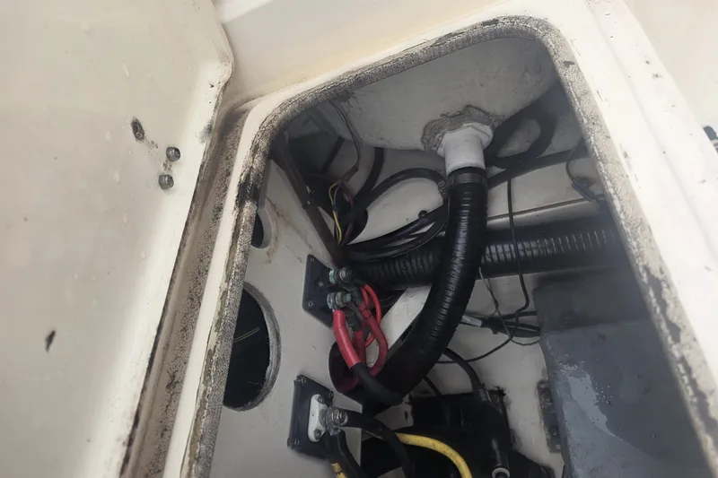 Slide: The Image of 2008 Scout 282 Sportfish boat wiring and components in storage compartment. - 14
